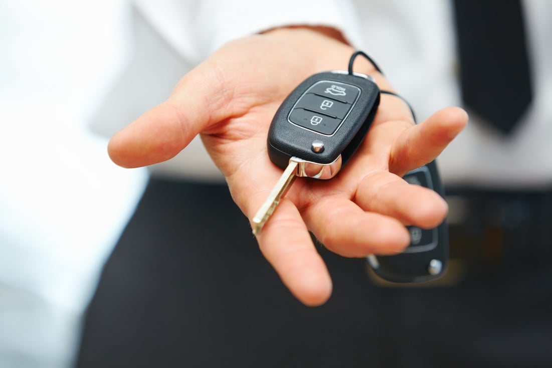 Car Keys. Seller hand giving keys